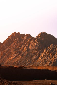 Captivating golden sunset illuminating the rugged mountains of Sharm El-Sheikh, Egypt.