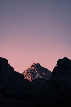 Capture of rugged mountains under a striking pink twilight sky in Sharm El-Sheikh, Egypt.