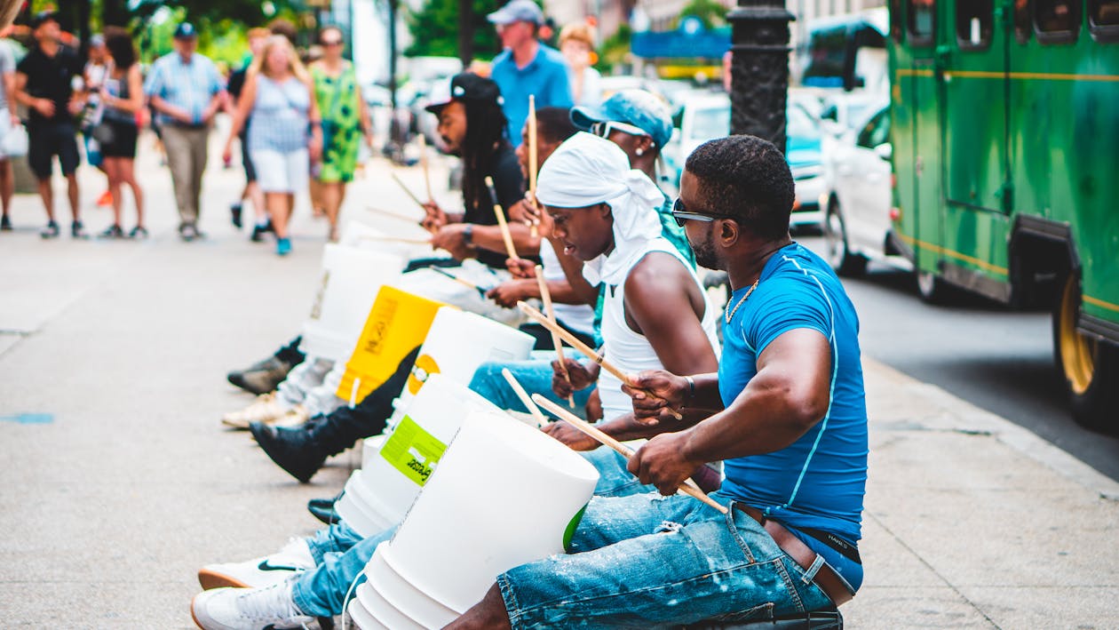 Free Group of Men Playing Drums Along The Street Stock Photo