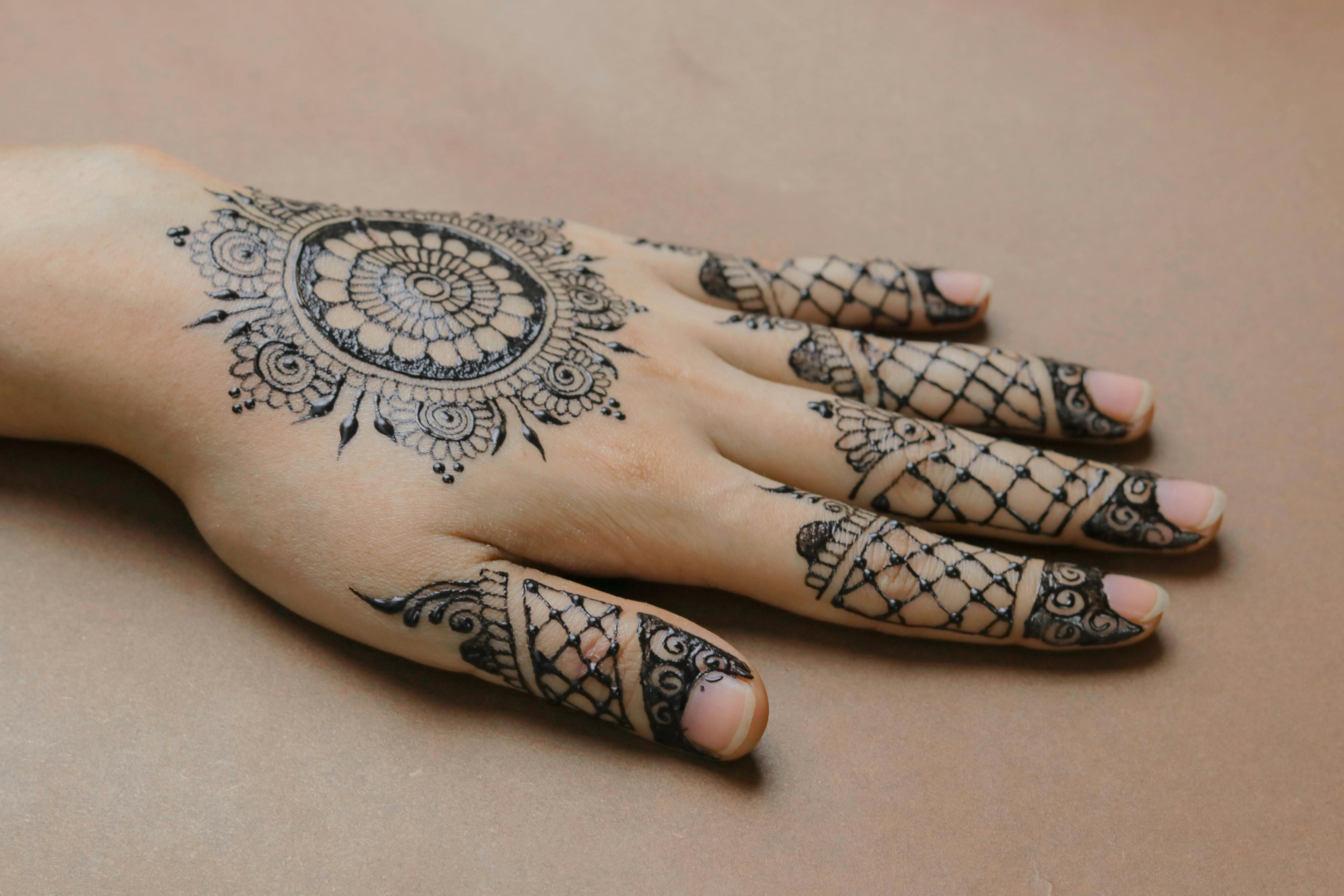 Henna Tattoo on Hand of Woman Holding Ring · Free Stock Photo