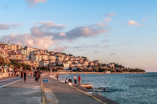 Free Enjoy a scenic walk along Istanbul's vibrant seaside promenade at sunset, capturing city life by the waterfront. Stock Photo