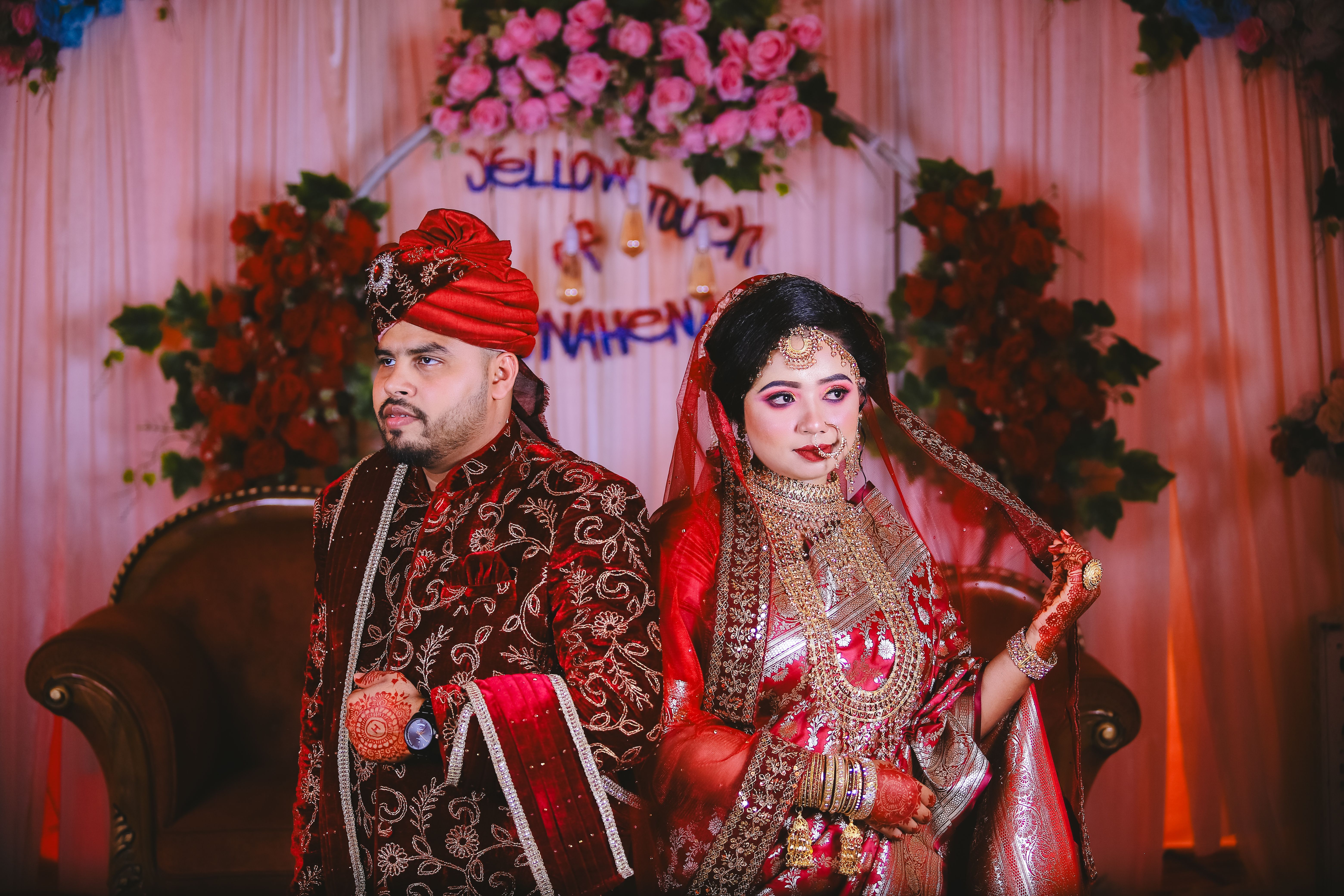 A couple in traditional attire posing for a photo · Free Stock Photo