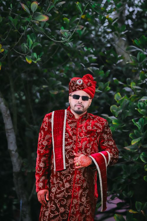 Groom in red sherwani