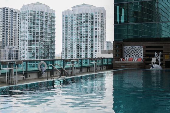Rooftop pool over a city skyline, by MINEIA MARTINS on Pexels