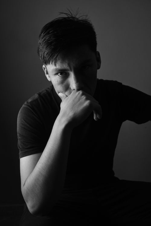 Free Expressive black and white portrait showcasing a contemplative man in dramatic lighting. Stock Photo