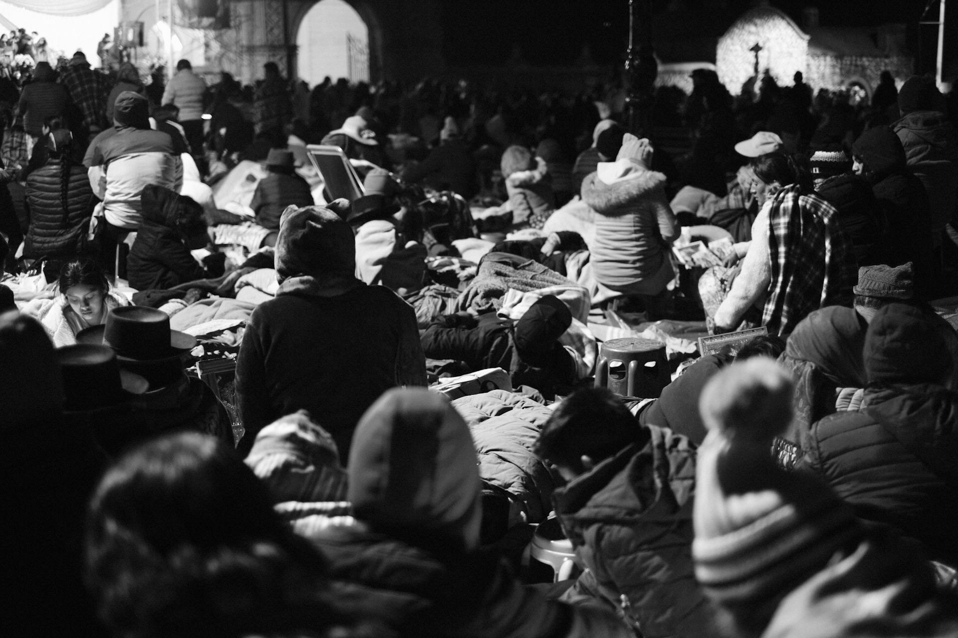 A vibrant black and white scene of a nighttime community gathering in Lima, Peru.