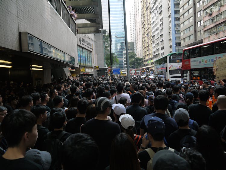 Ethnic Group Of People Moving In Street