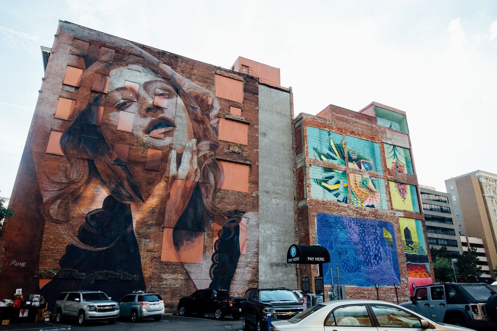 Colourful large-scale murals covering neighbouring studio buildings