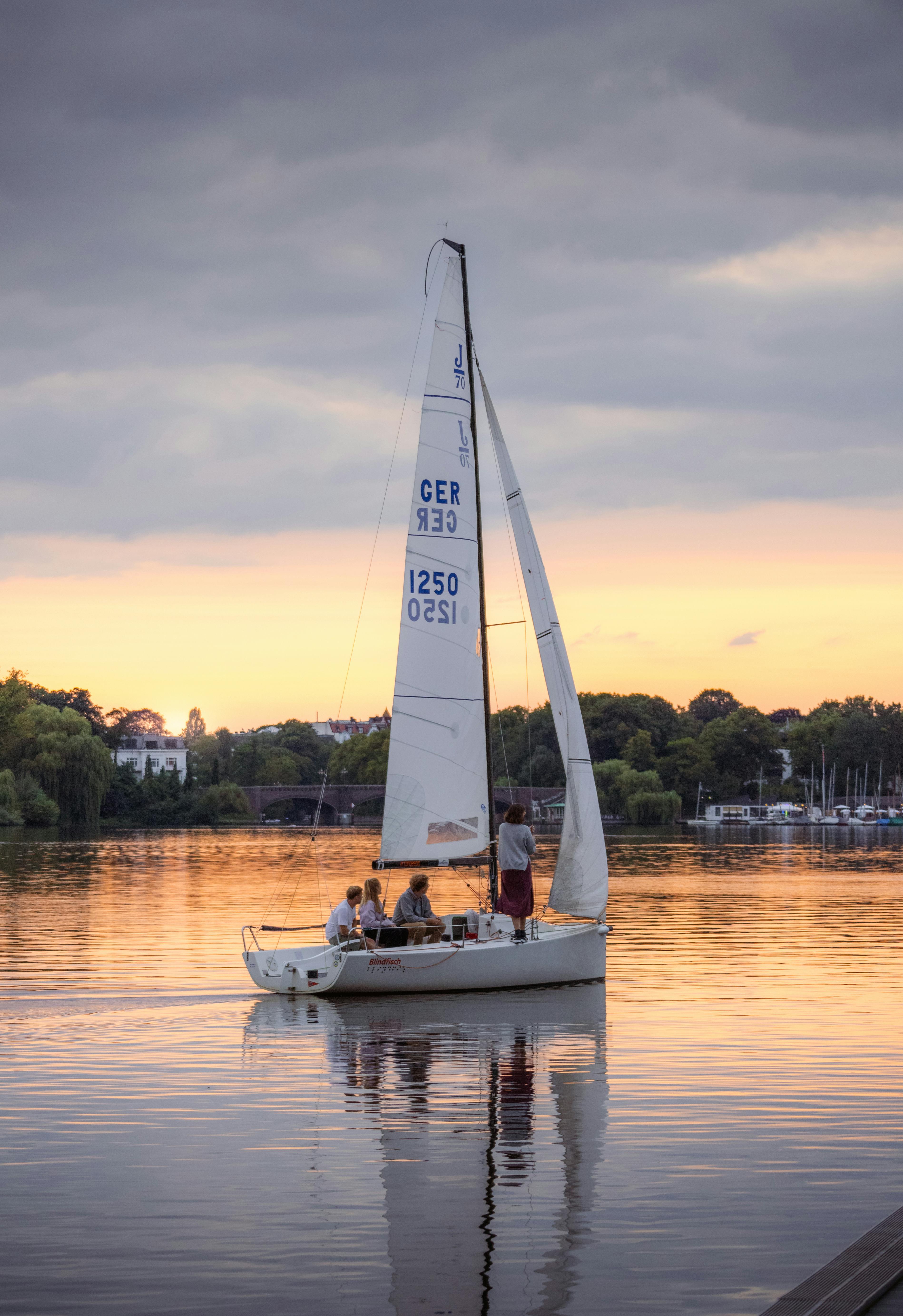 a sailboat on the water at sunset