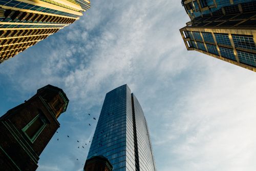 Free Dynamic perspective of modern skyscrapers against a clear blue sky. Stock Photo