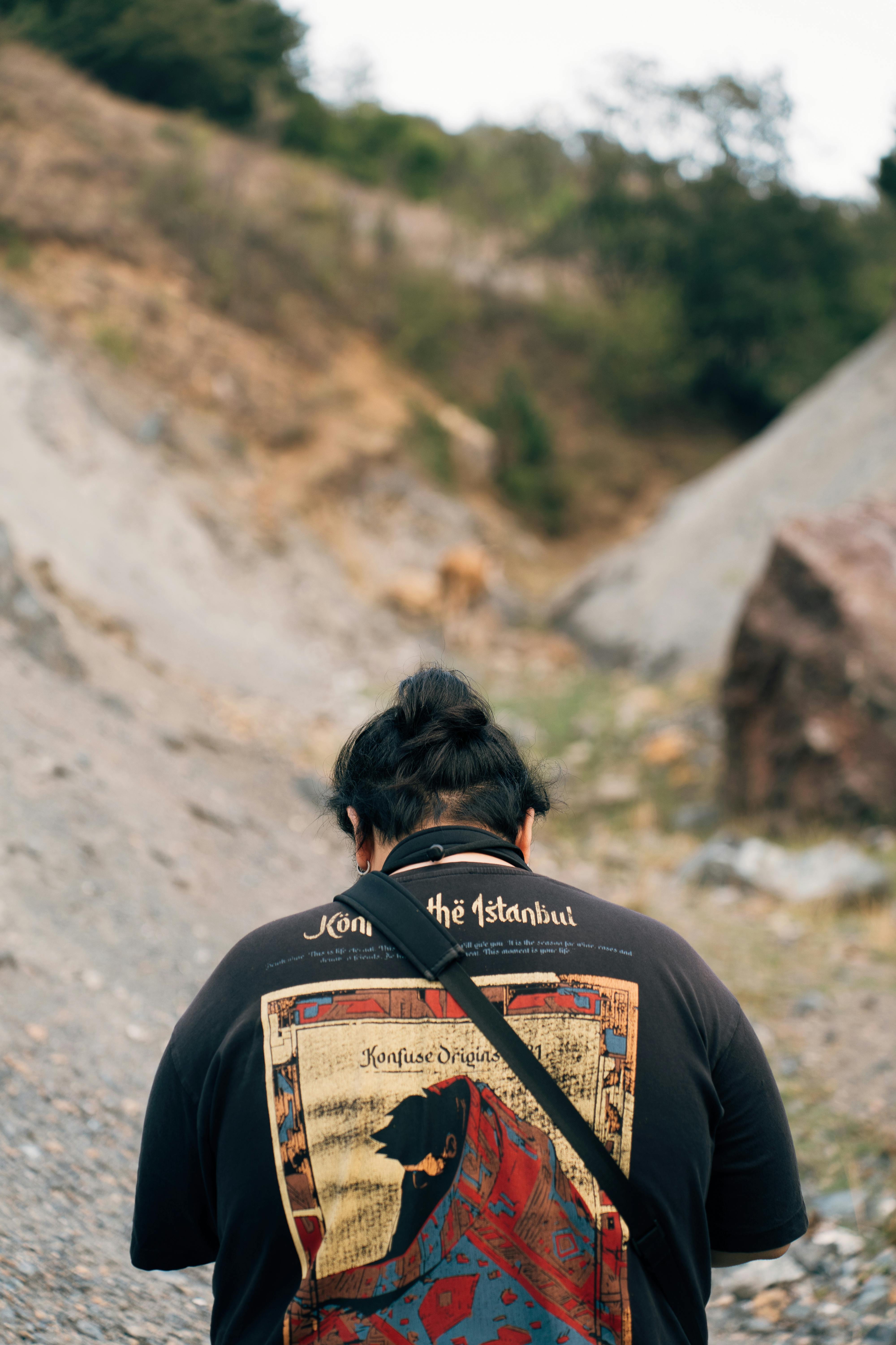 a man with a backpack on a dirt road