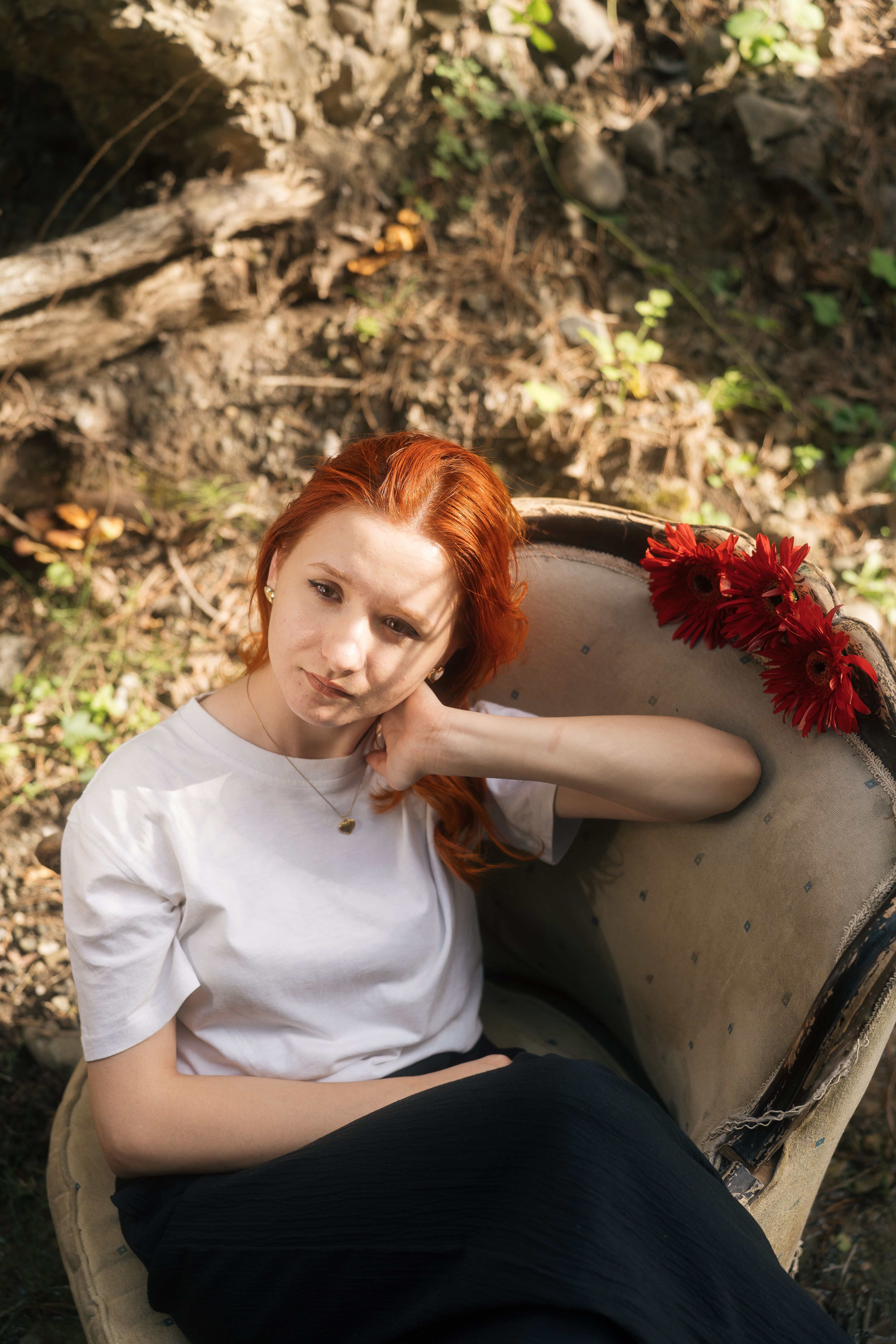 A woman with red hair sitting in a chair · Free Stock Photo