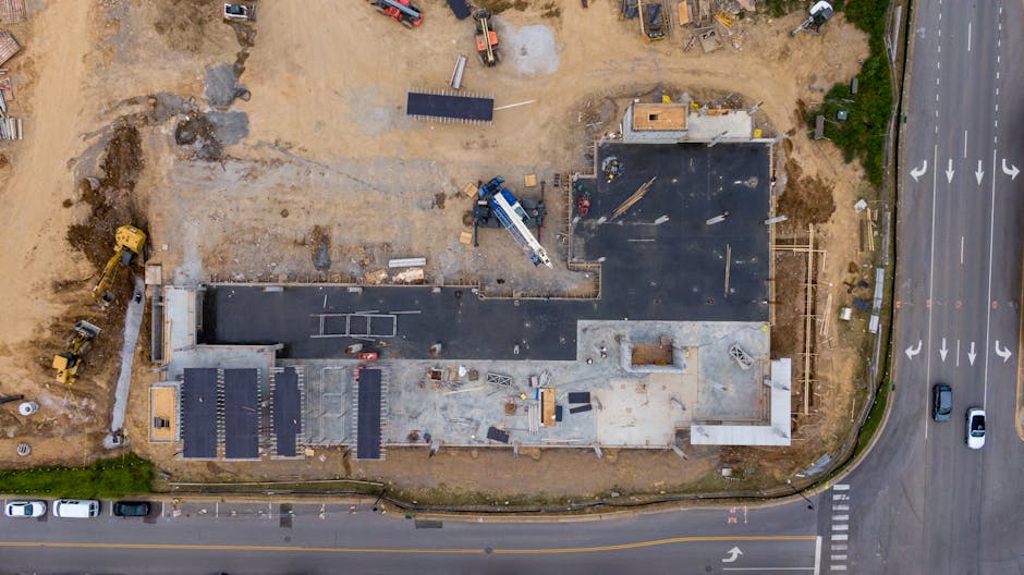 drone capturing aerial footage of construction site with workers and equipment - how to market construction company