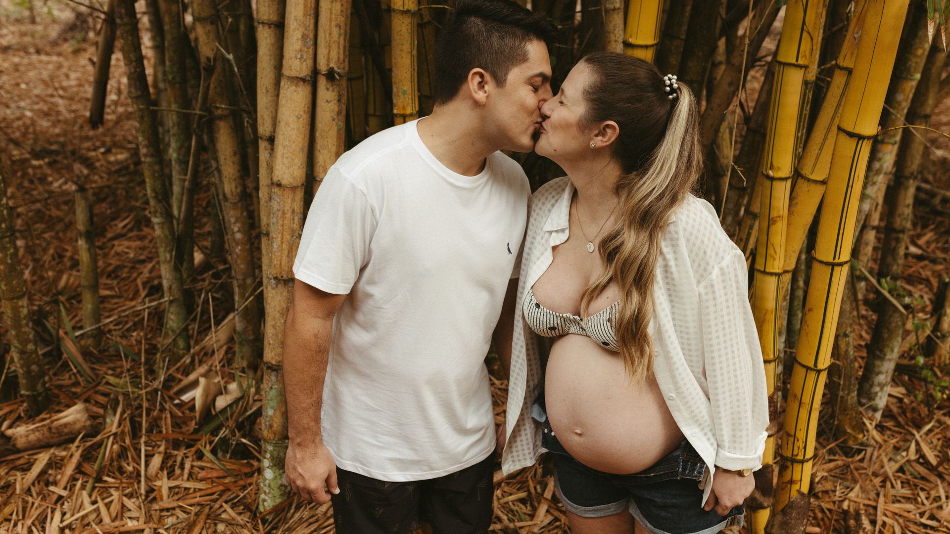 Modafinil Safety While Breastfeeding: A Comprehensive Guide Couple sharing a romantic kiss outdoors, celebrating pregnancy in a serene bamboo forest setting — modafinil safety while breastfeeding