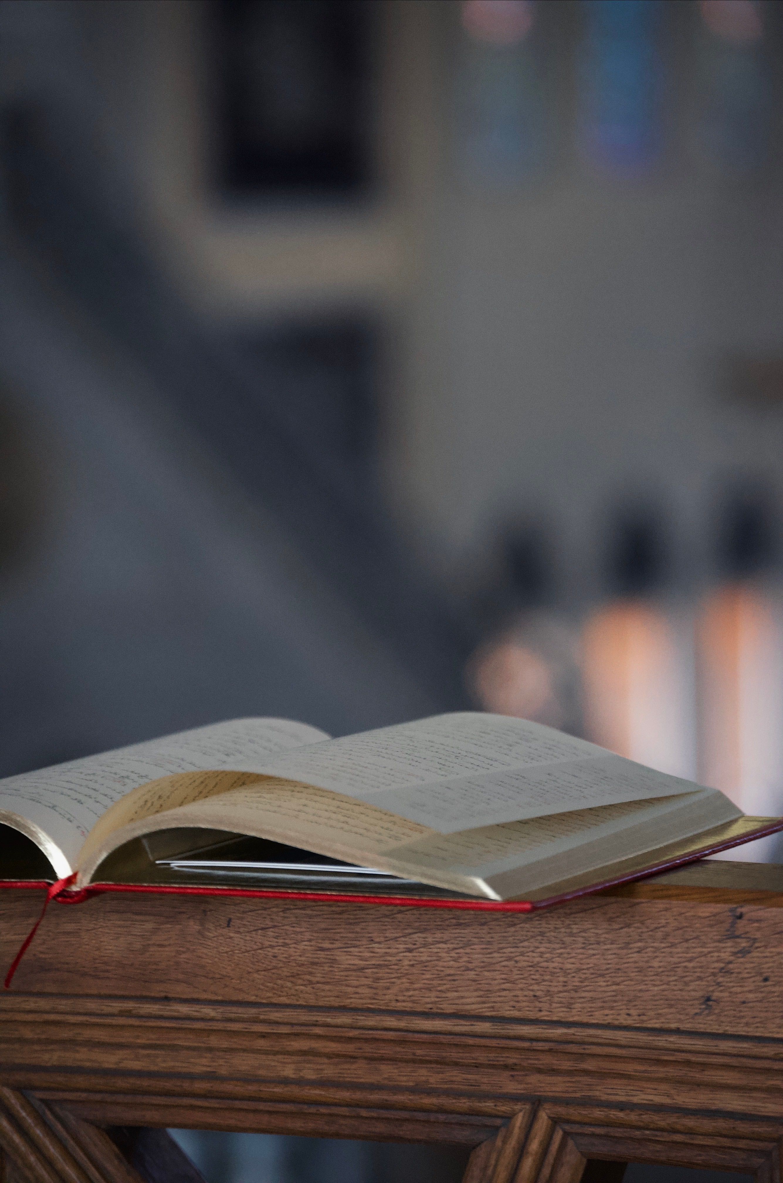 Open Book on Wooden Rail in Quiet Library · Free Stock Photo