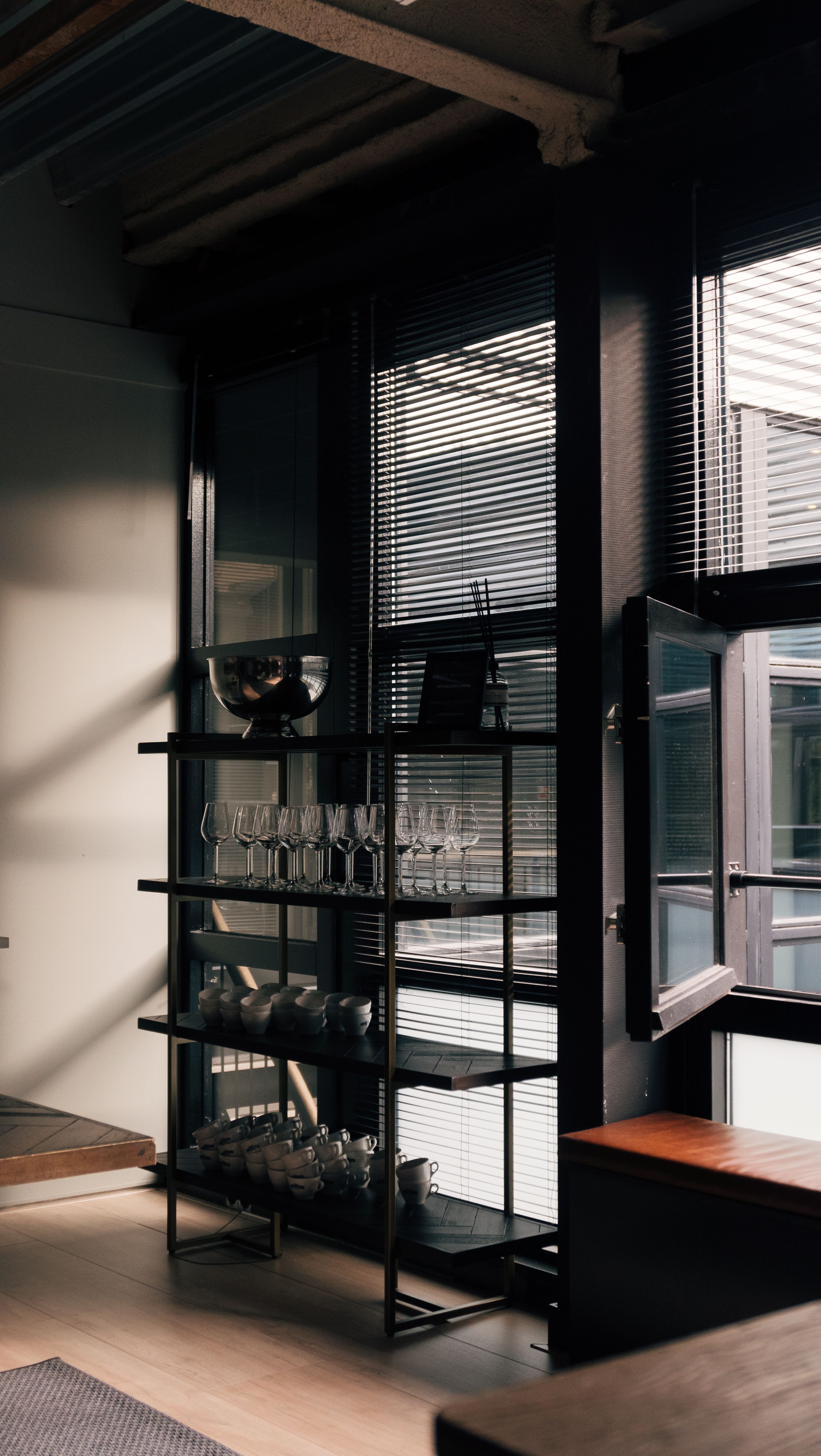 Stylish industrial loft interior in Amsterdam with glass shelving and natural light.. stylish, industrial, loft