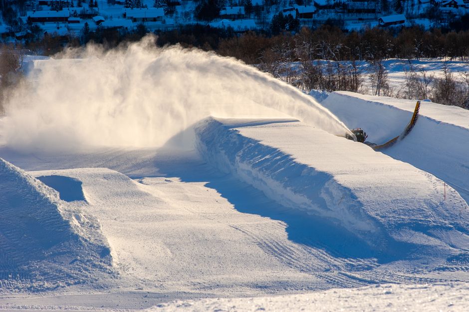 Snow blower shaping a ski halfpipe in Geilo, Norway. Winter landscape at a ski resort.