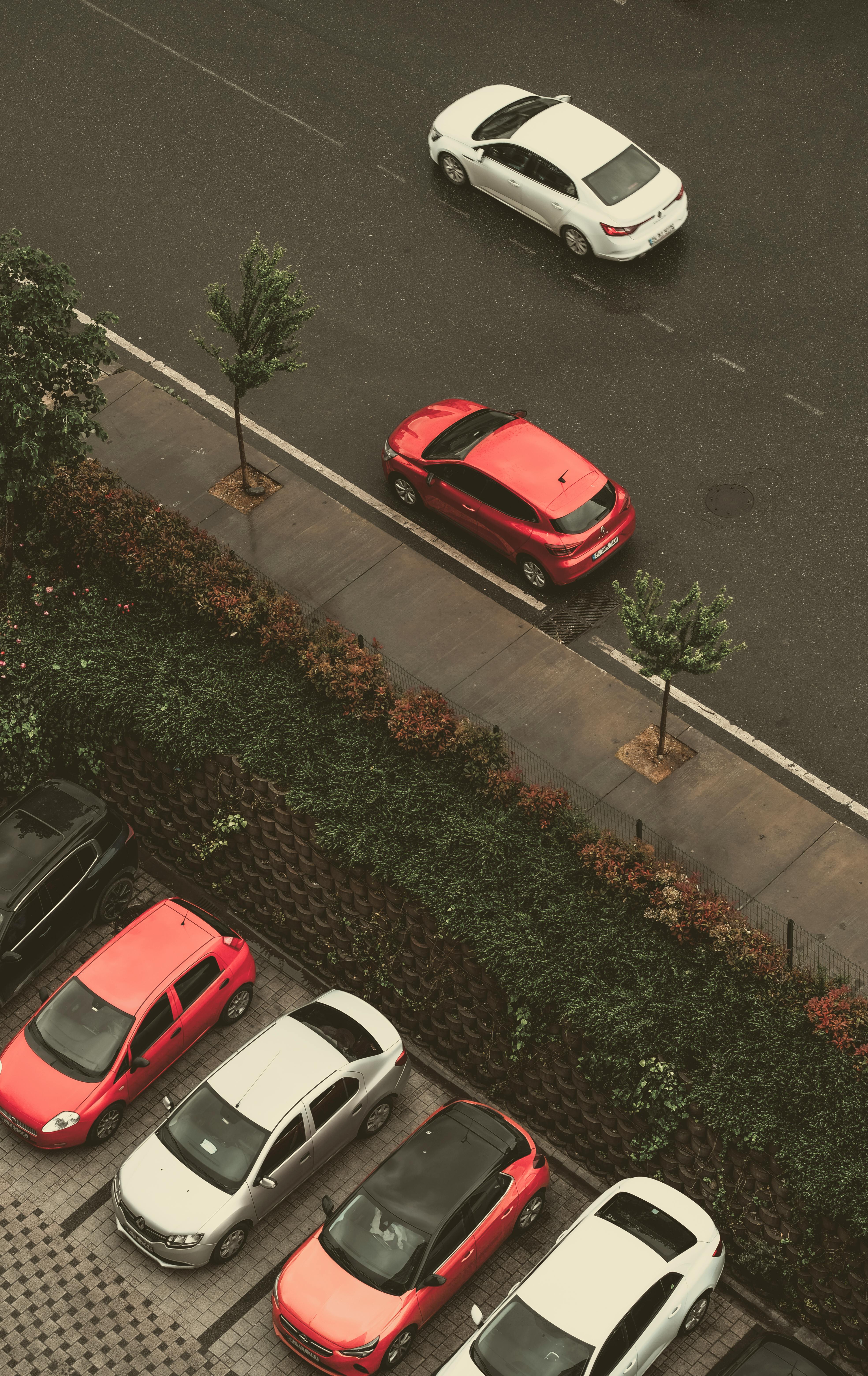 Top-down view of red and white cars on a wet road in Istanbul, Turkey.