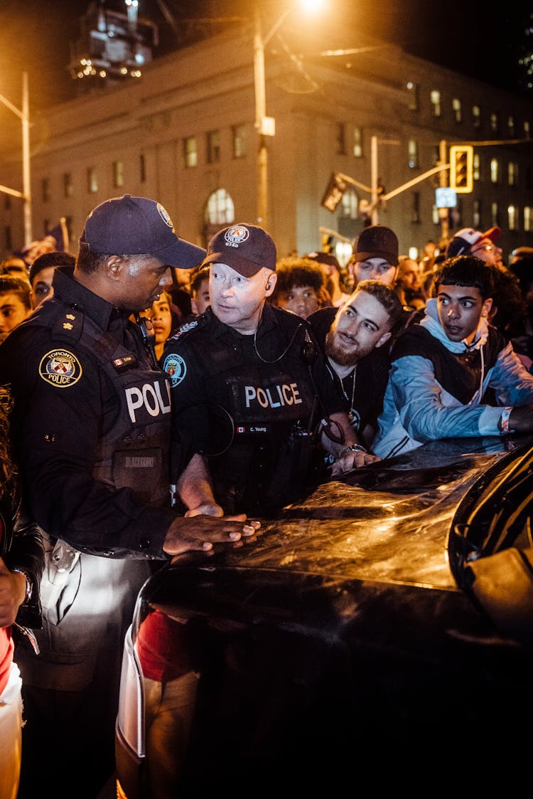 Police Men With A Group Of People In A Rally