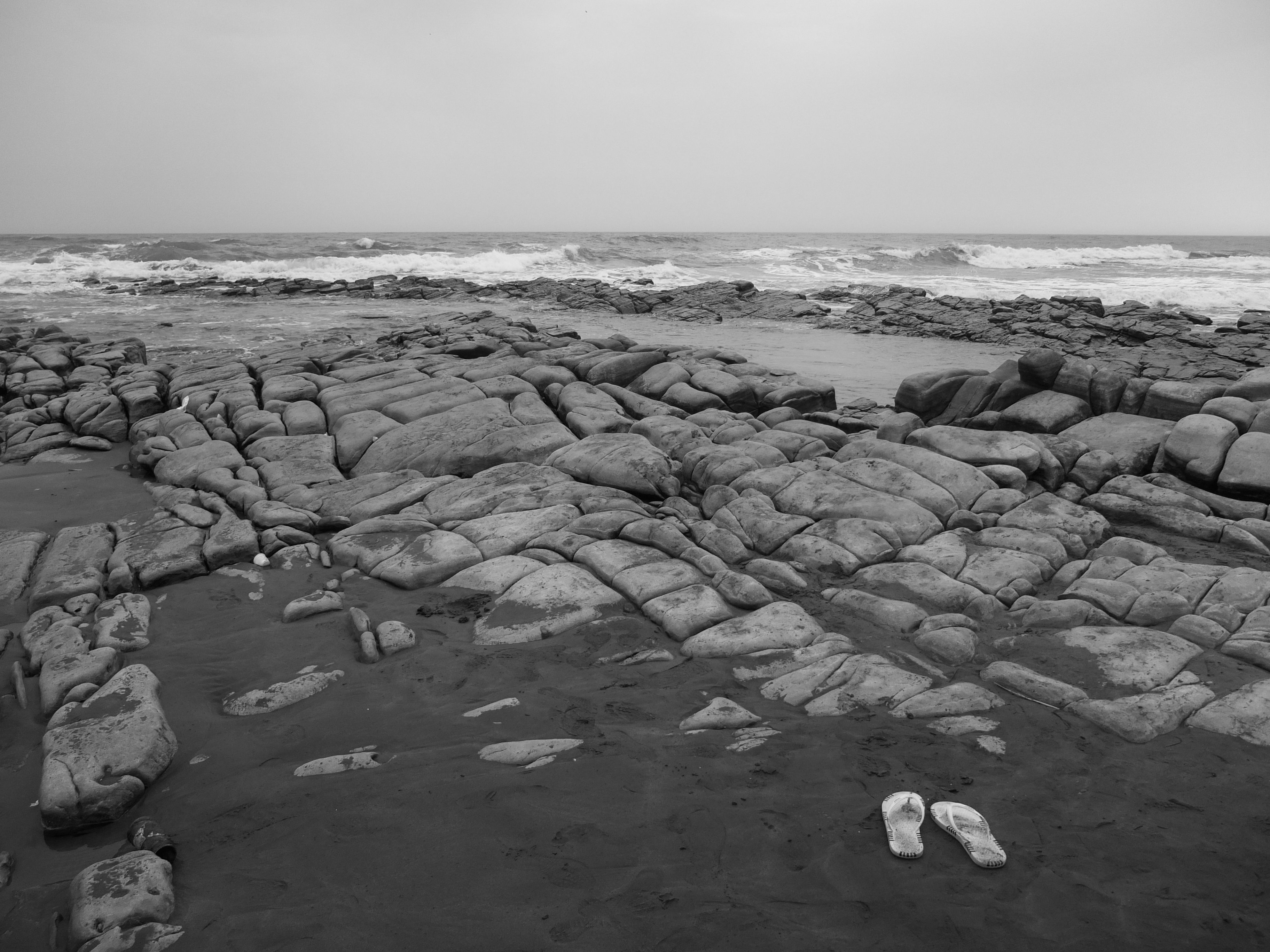 Flip Flops and Rocks at Beach on Seashore · Free Stock Photo
