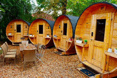 Free Cozy wooden barrel cabins in a serene forest, perfect for outdoor retreats. Stock Photo