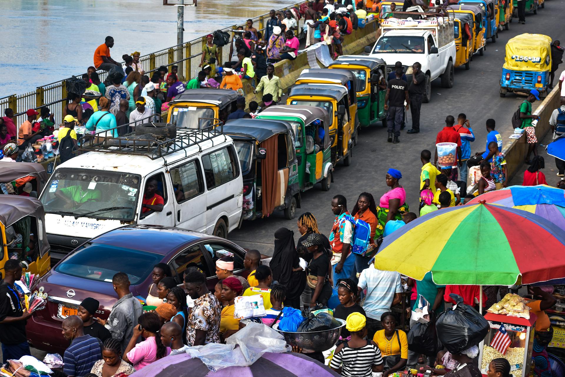 Colorful scene of a bustling market and traffic in Monrovia, Liberia showcasing local life.
