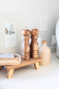 Aesthetic close-up of wooden kitchen accessories in a bright, modern kitchen.
