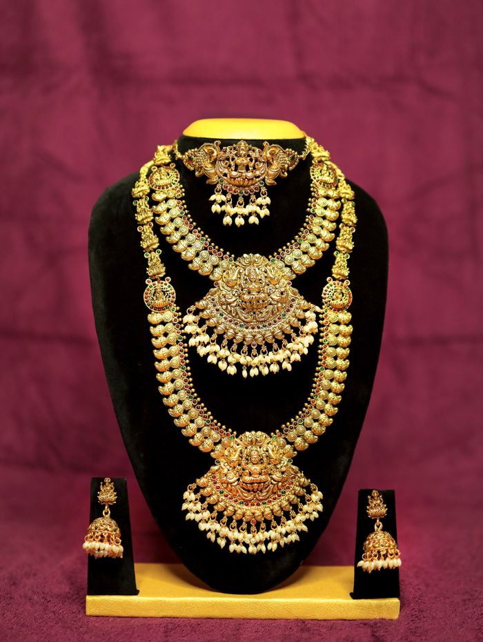 Temple gold bridal jewellery set — tiered haram necklaces and jhumkas