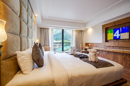 Elegant hotel room with a large bed and scenic mountain view from the window, ideal for comfortable stay
