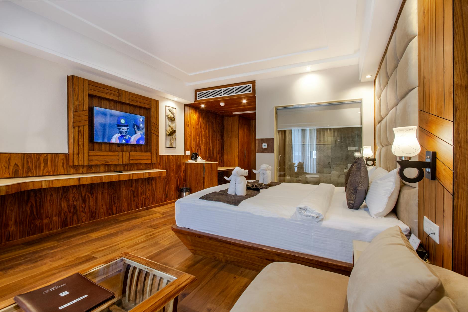 a-hotel-room-with-a-bed-television-and-wooden-floors-Hotels Near Universal Studios Orlando