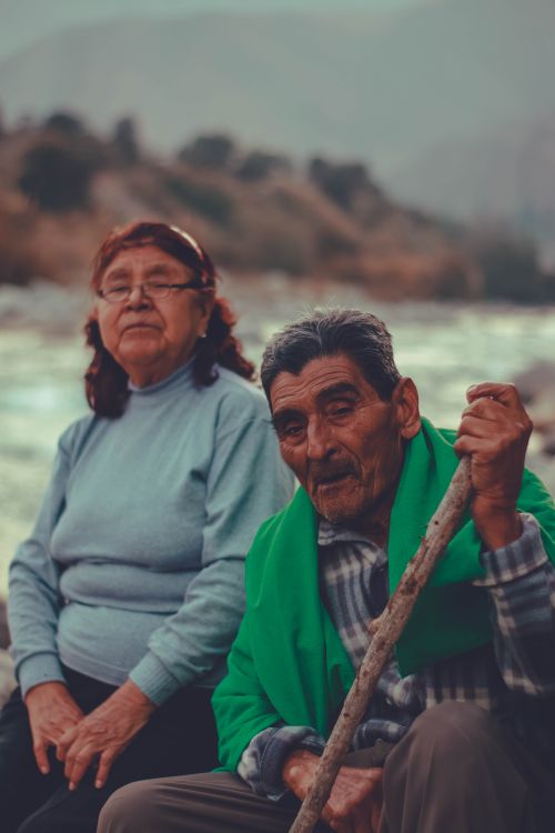Free Elderly couple enjoying a serene riverside moment in Lima, Peru. Perfect for travel and lifestyle themes. Stock Photo