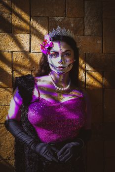 A striking, backlit portrait of a woman in a sequin dress and skull makeup, embodying dramatic fashion.