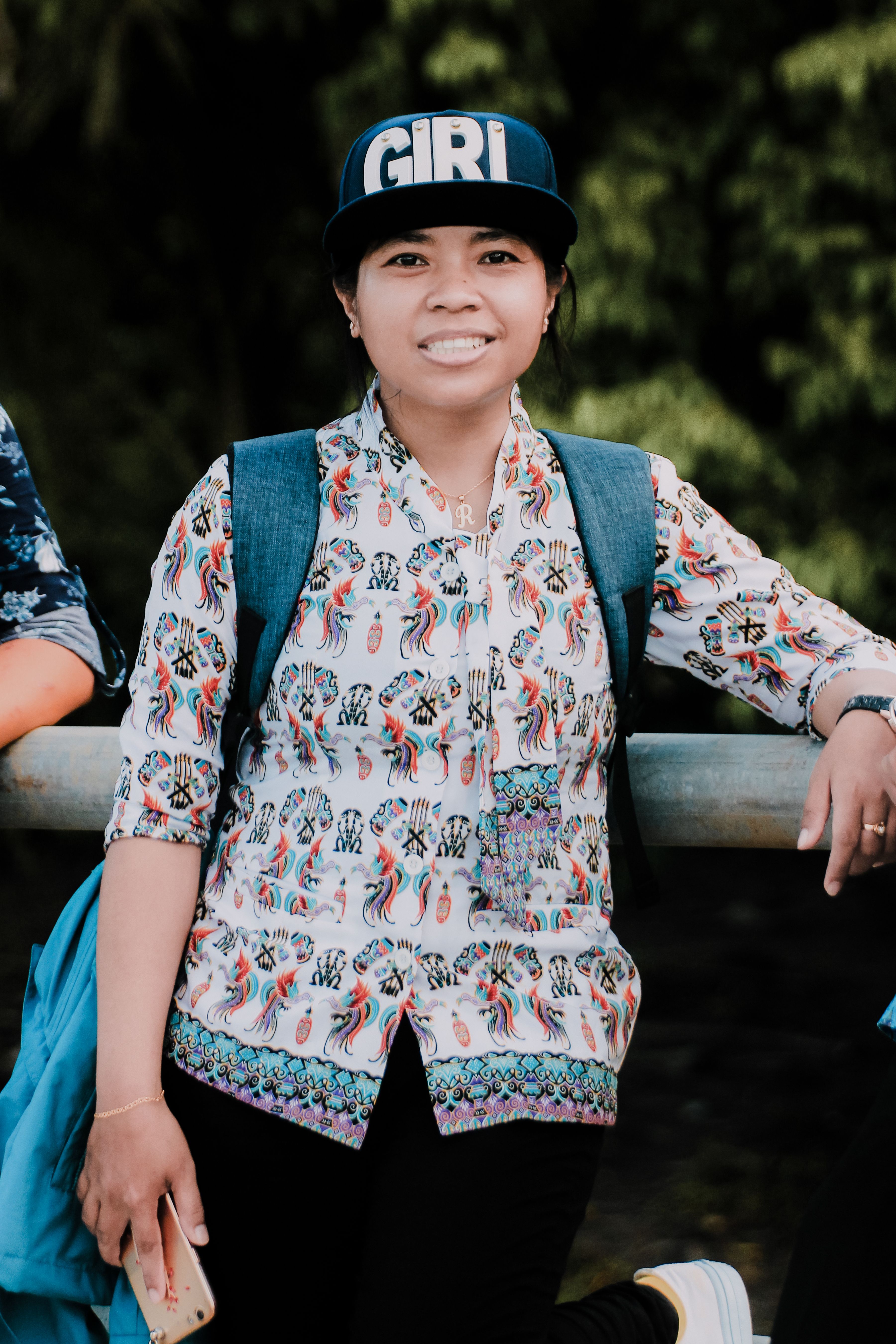 Woman posing outdoors in Agats, Papua, Indonesia, wearing casual patterned attire and a hat.