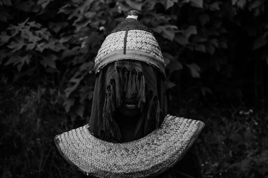 A striking black and white portrait showcasing traditional African attire and cultural heritage.