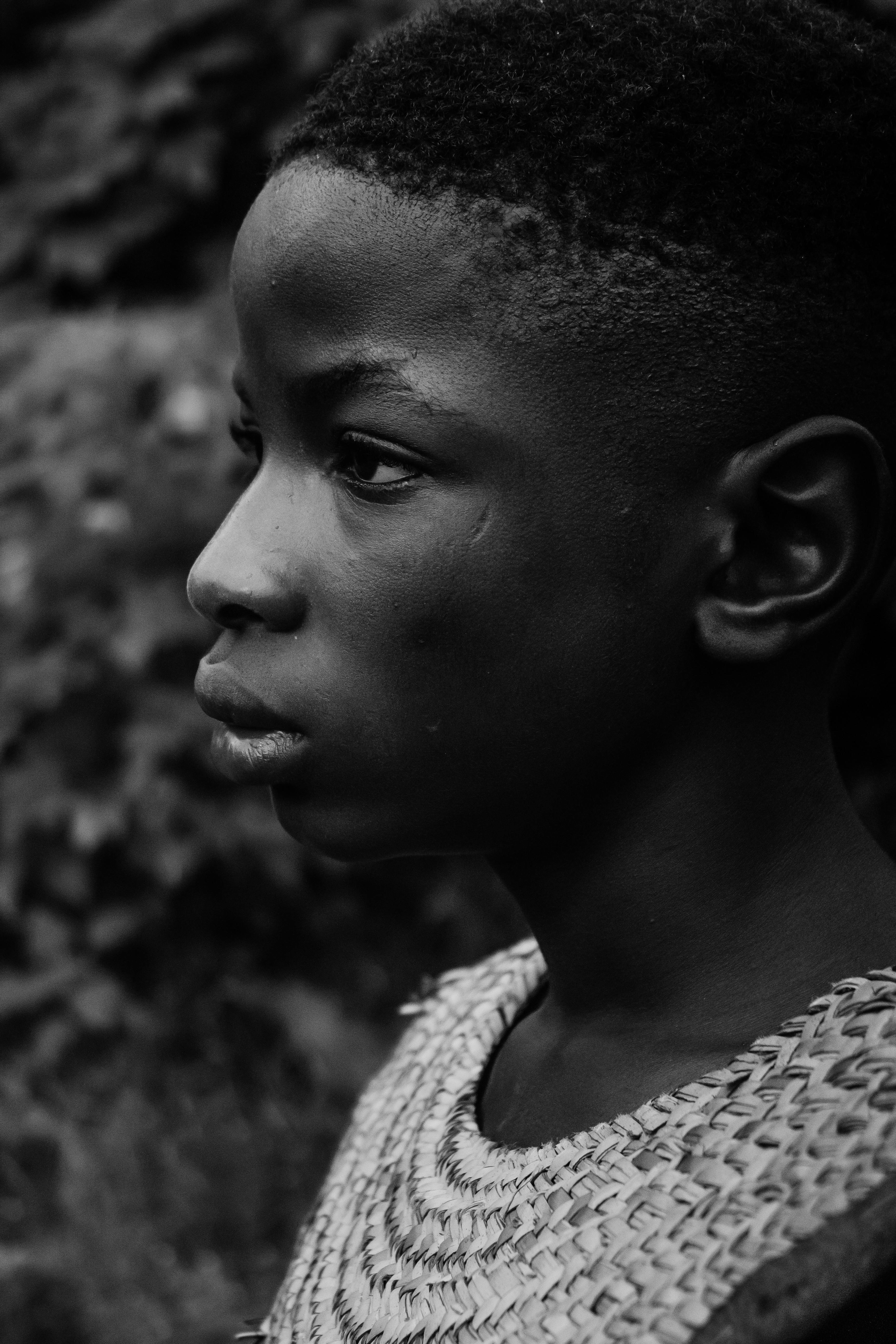 Striking black and white portrait of a young boy in contemplative mood.