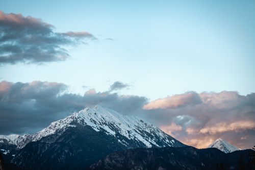 Free Capture of a snowcapped mountain during sunset, highlighting natural beauty and scenic winter landscape. Stock Photo