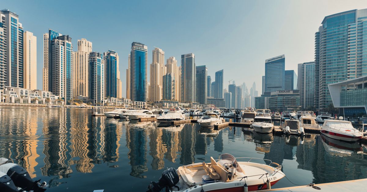 Explore the breathtaking Dubai Marina skyline with luxurious yachts docked on a serene waterfront.