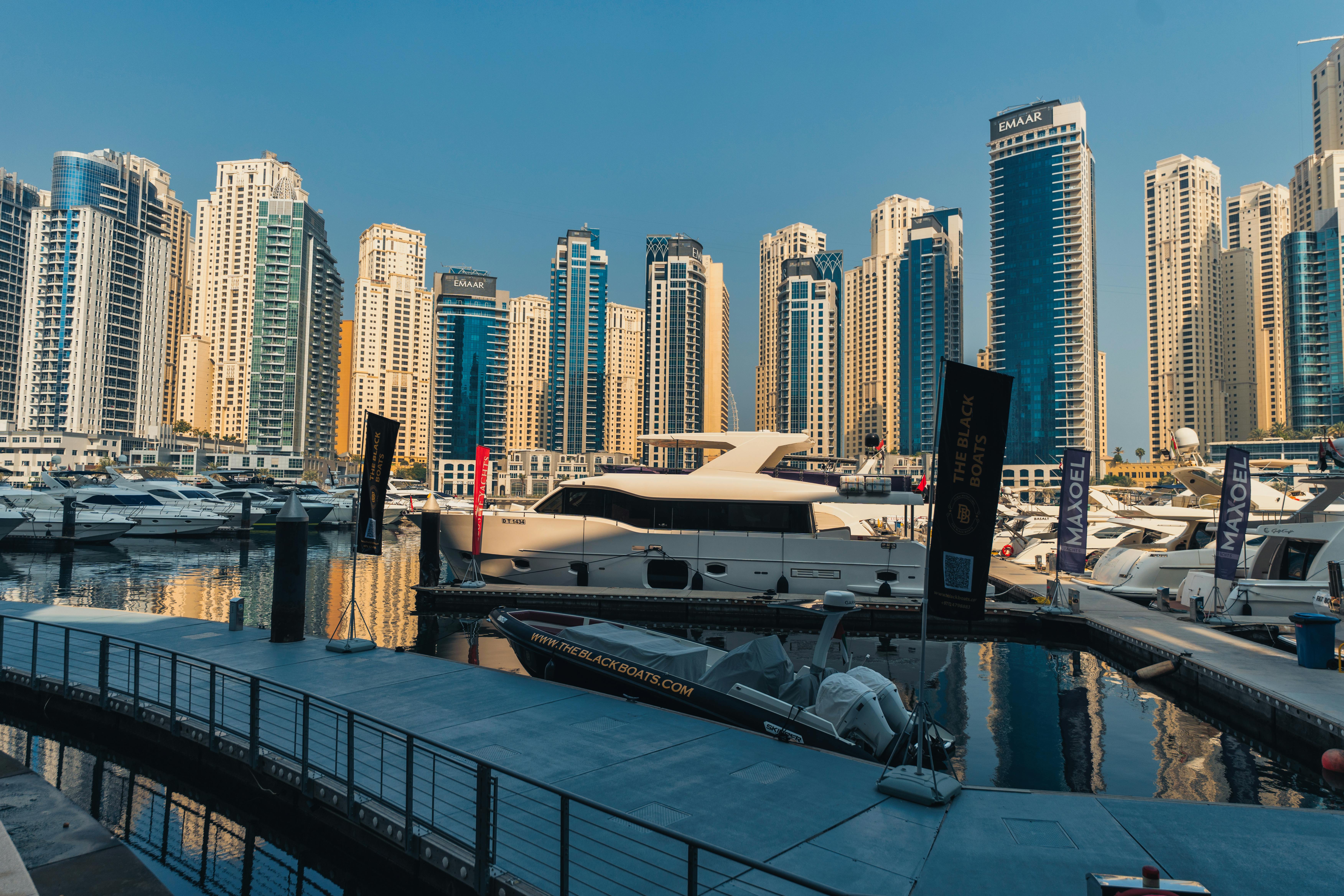 Luxury yachts anchored in Dubai Marina with towering skyscrapers. Perfect for travel and urban explo