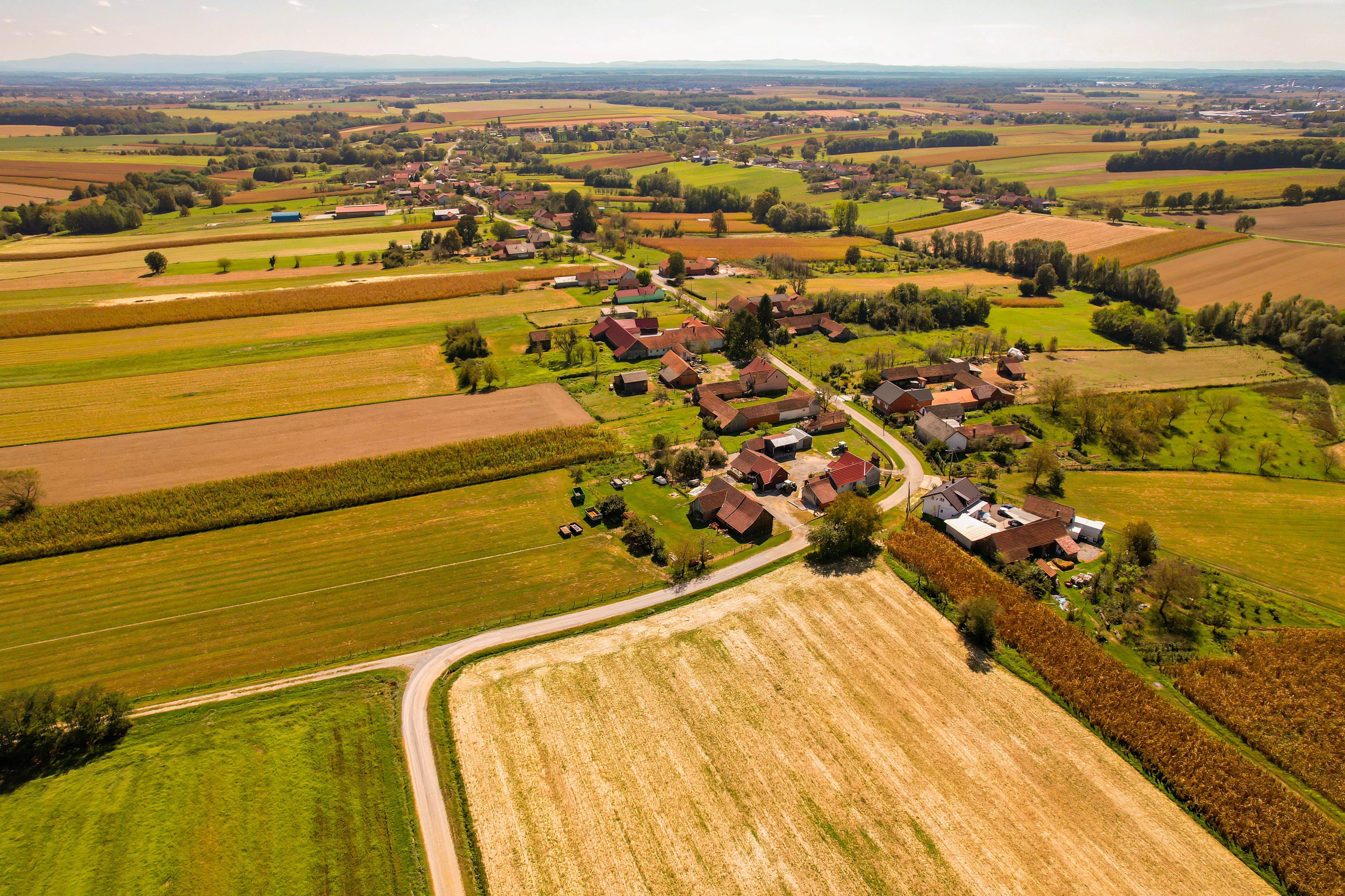 Road Through Fields and Village from a Birds Eye View · Free Stock Photo