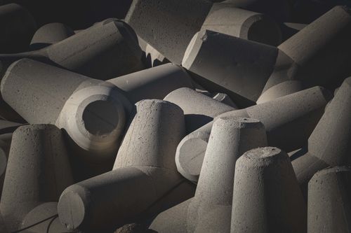 Free Close-up image of concrete tetrapods used for coastal protection and wave dispersion. Stock Photo
