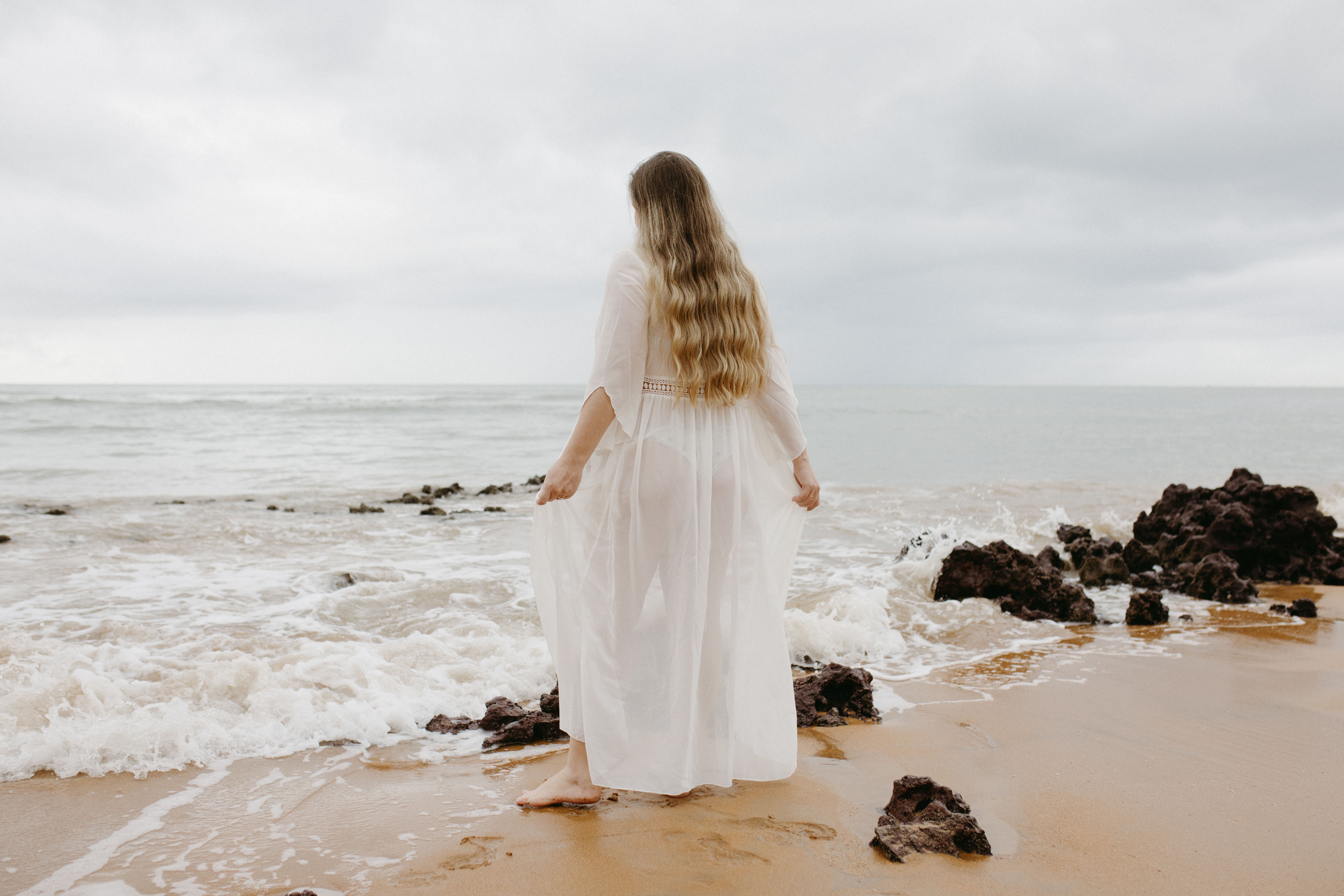 A Woman Standing on a Beach  Free Stock Photo