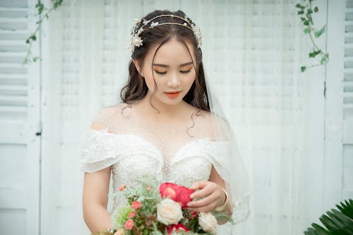 Photo Of Woman Holding A Bouquet Of Flowers