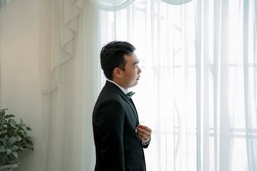 Фотография человека, стоящего возле окна