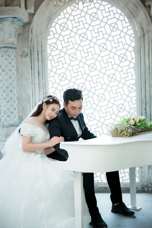 Photo Of Man And Woman Playing Piano