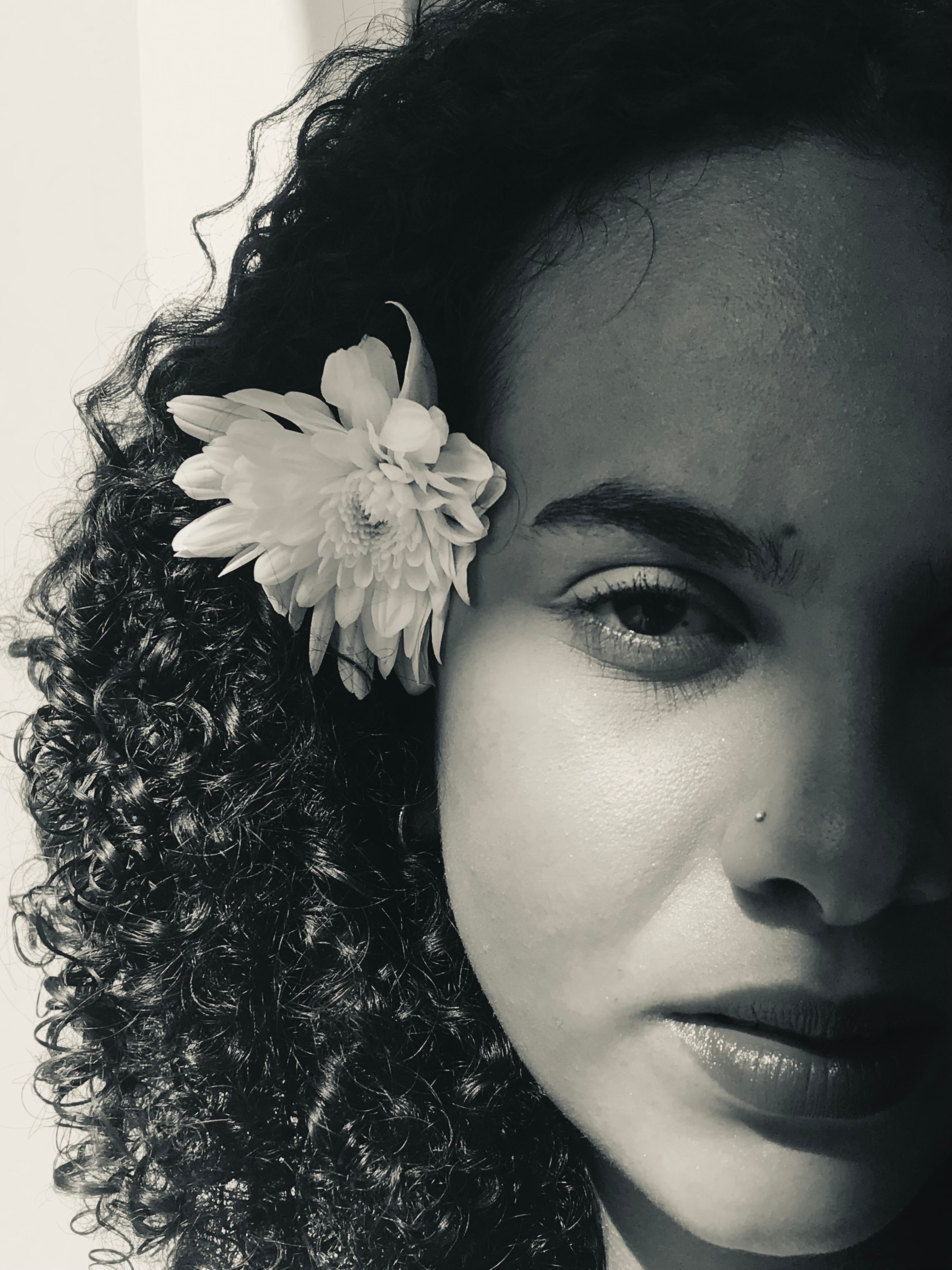 Portrait of a Woman with a Flower in her Hair · Free Stock Photo