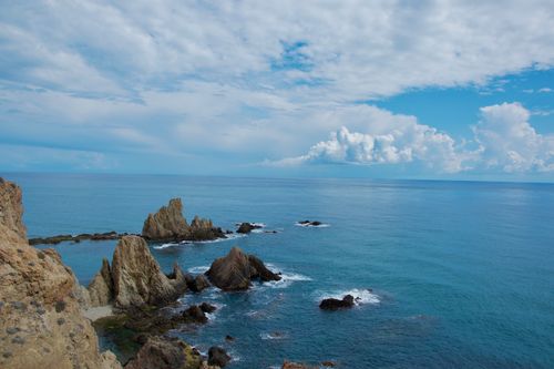 Free Breathtaking view of rocky seascape at Cabo de Gata in Spain with azure blue sea and sky. Stock Photo