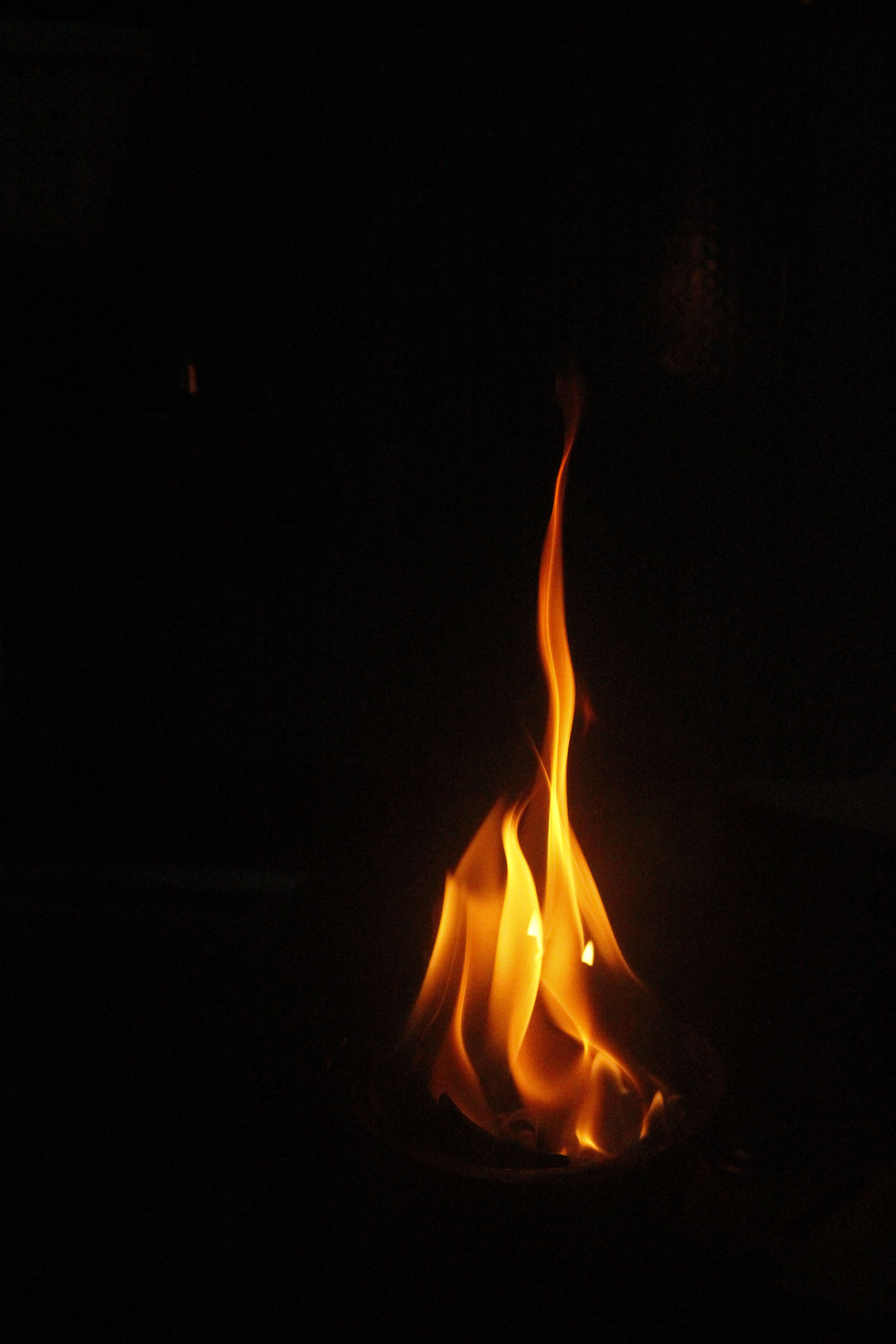 A captivating view of flames dancing in the dark, creating a warm ambiance.