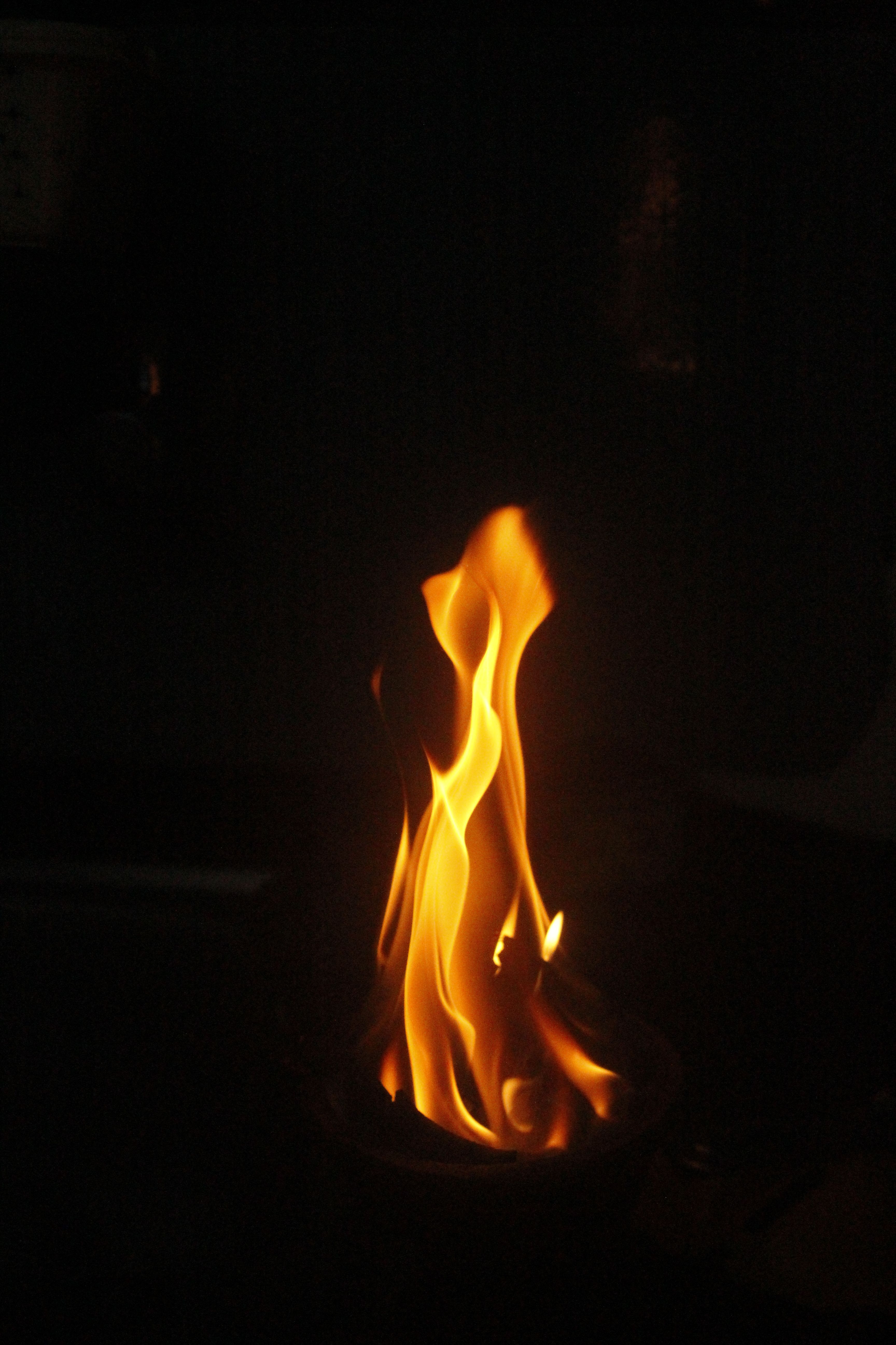 A mesmerizing flame captured in the dark, exuding warmth and energy.
