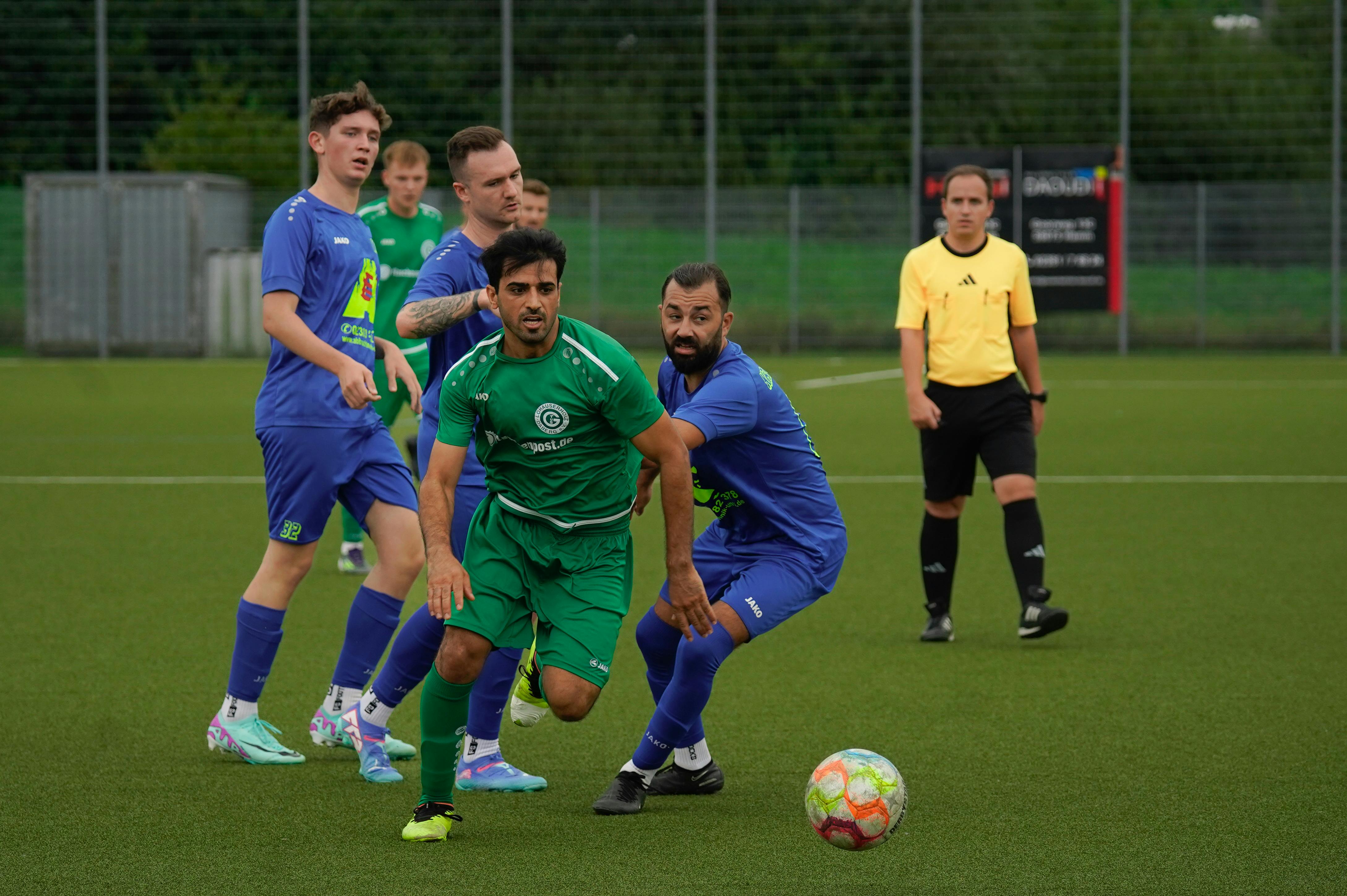 Intense soccer match between two teams, showcasing athletic performance on a grass field.