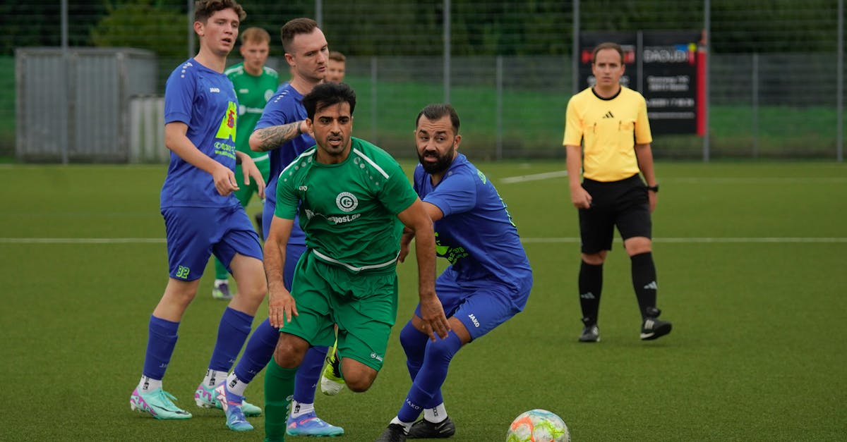 Intense soccer match between two teams, showcasing athletic performance on a grass field.
